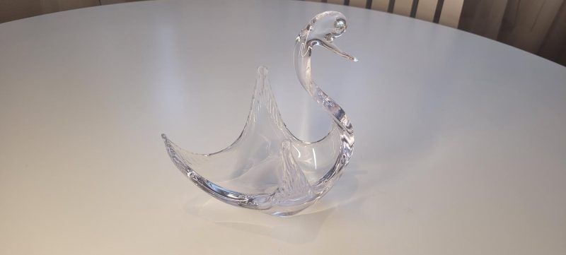 Svan i glas med uppspärrade vingar och vackert krökt hals
